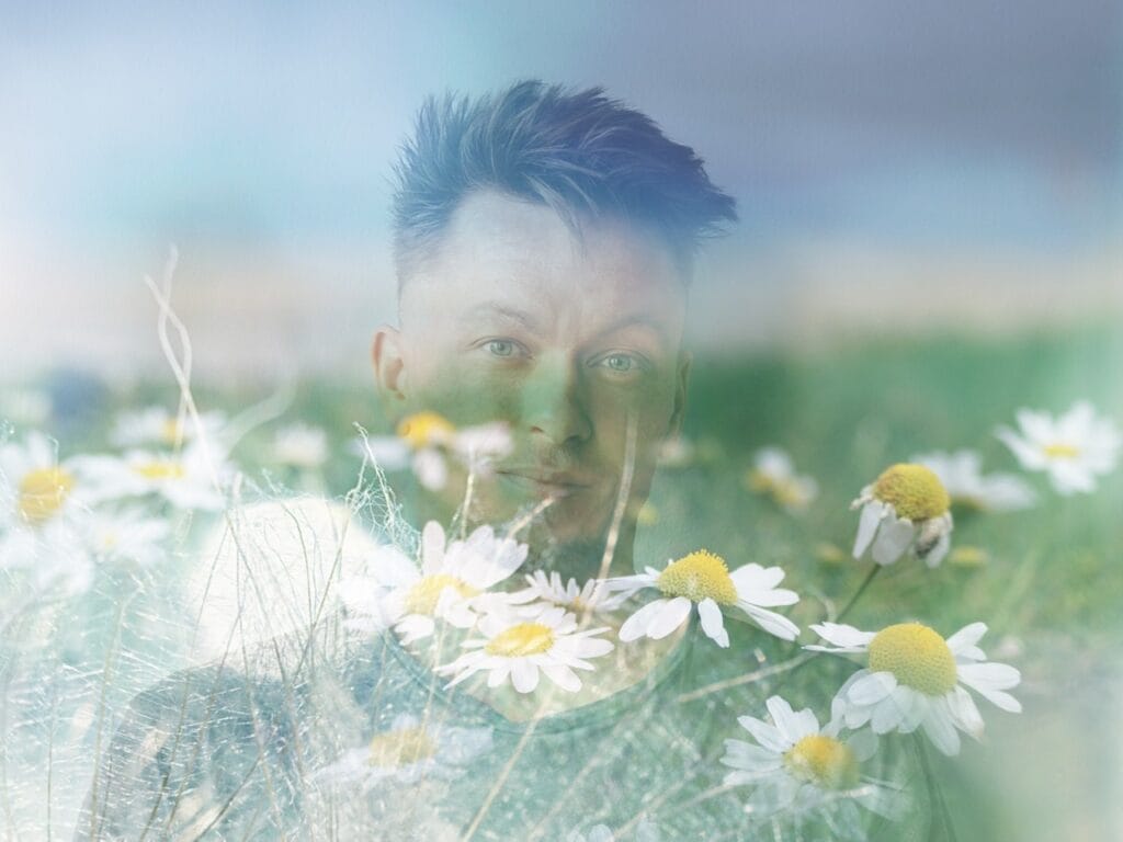 Layered close-up of intuitive coach Jaden Healey with flowers, symbolizing attunement to nature and intuitive insight.